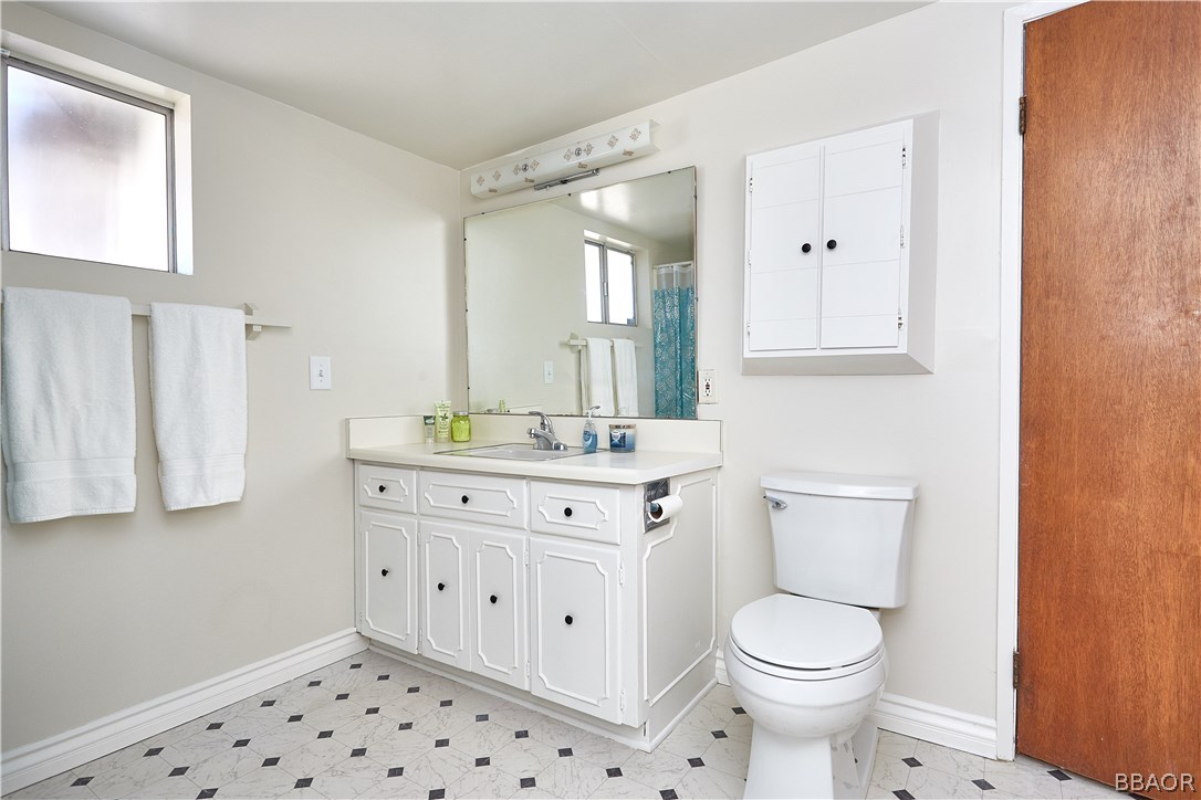 19616 Huasna Road Apple Valley, CA 92307 - Photo 32 of 48 a bathroom with a sink a toilet and mirror