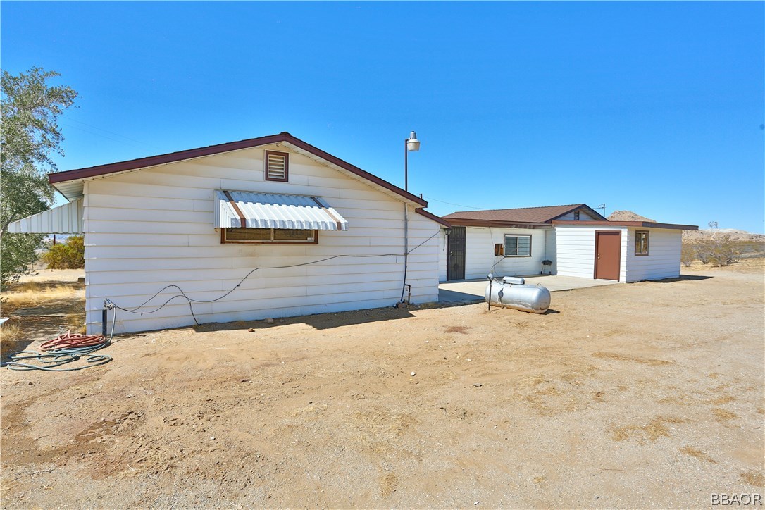 19616 Huasna Road Apple Valley, CA 92307 - Photo 36 of 48 a front view of a house with a yard