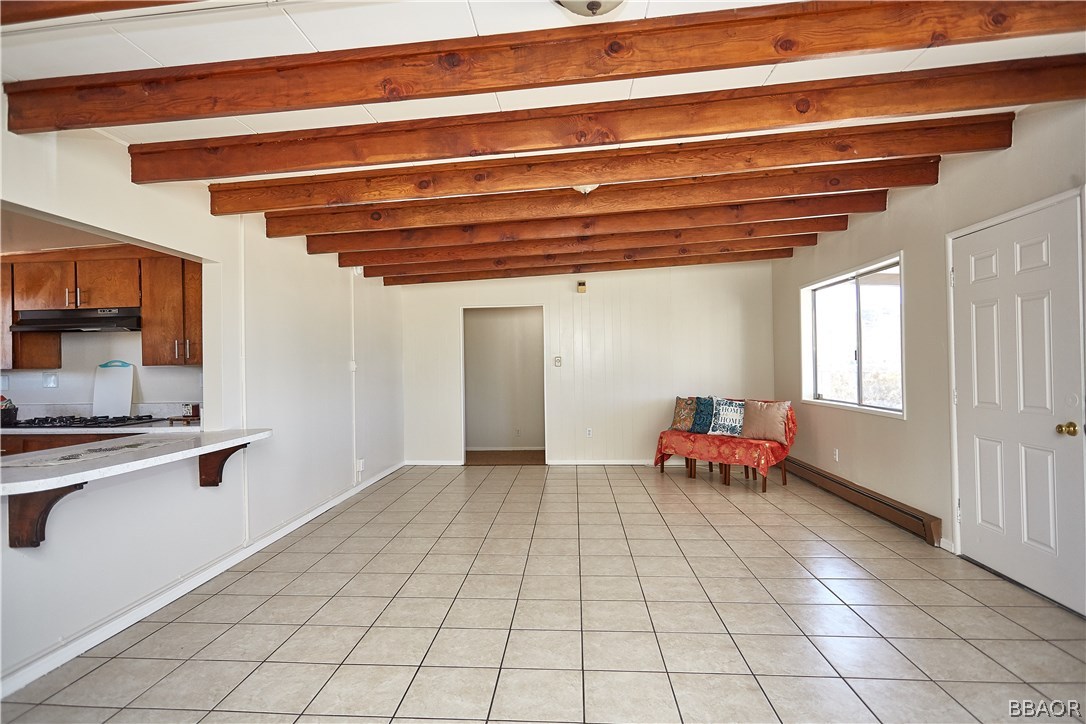 19616 Huasna Road Apple Valley, CA 92307 - Photo 8 of 48 a hallway with a white cabinet a rug and a window