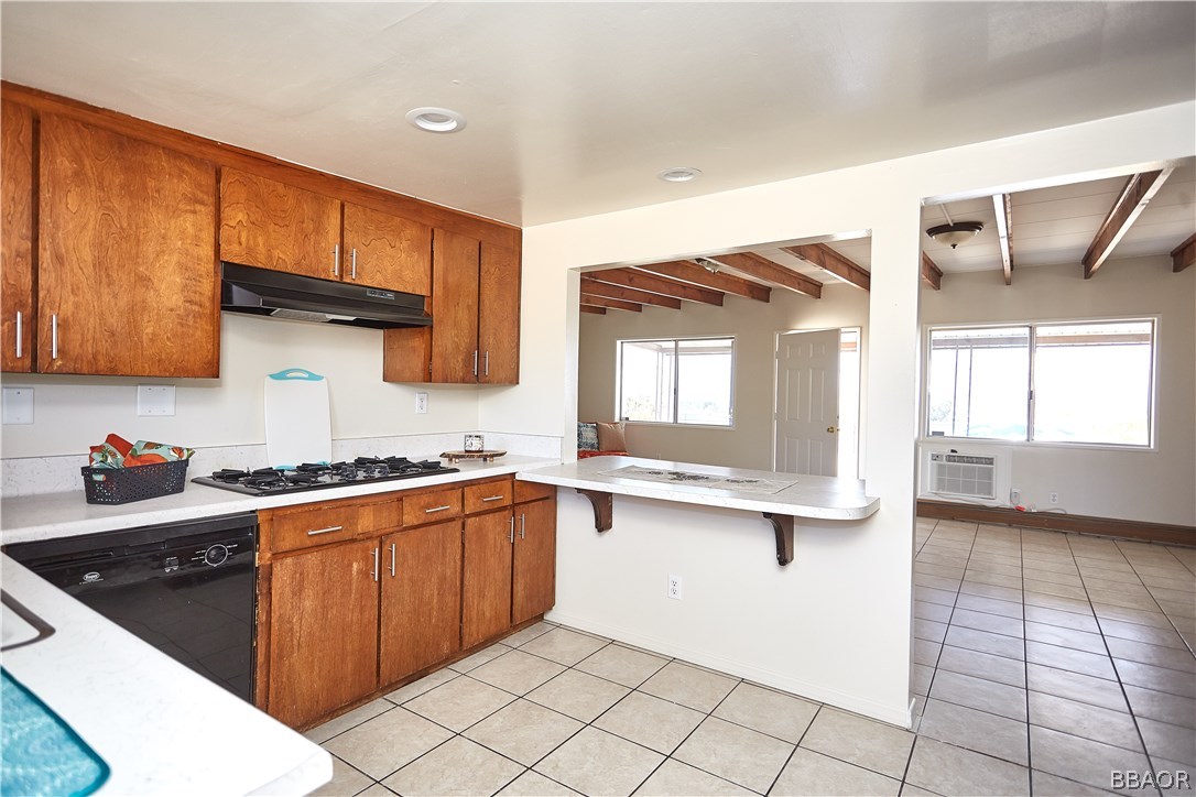 19616 Huasna Road Apple Valley, CA 92307 - Photo 10 of 48 a kitchen with stainless steel appliances granite countertop a stove a sink and a microwave