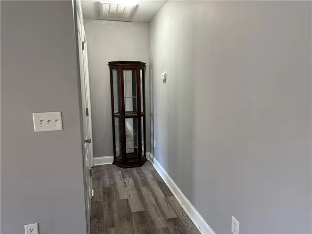 a view of hallway with wooden floor