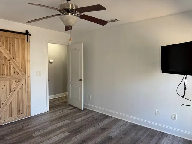 a view of a room with wooden floor and windows
