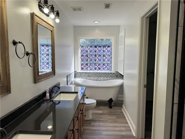 a view of a hallway with paintings on the wall