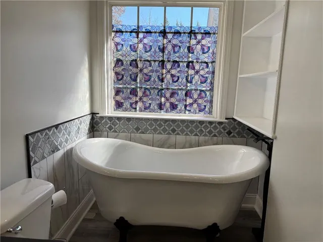 a bathroom with a bathtub and shower