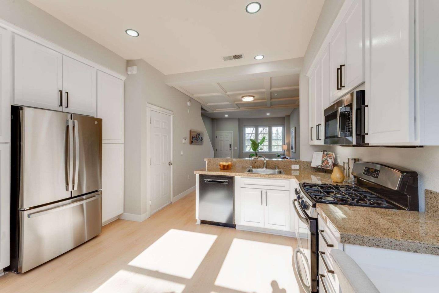 885 Frederick Commons San Jose, CA 95126 - Photo 11 of 30 a kitchen with a refrigerator and a stove top oven