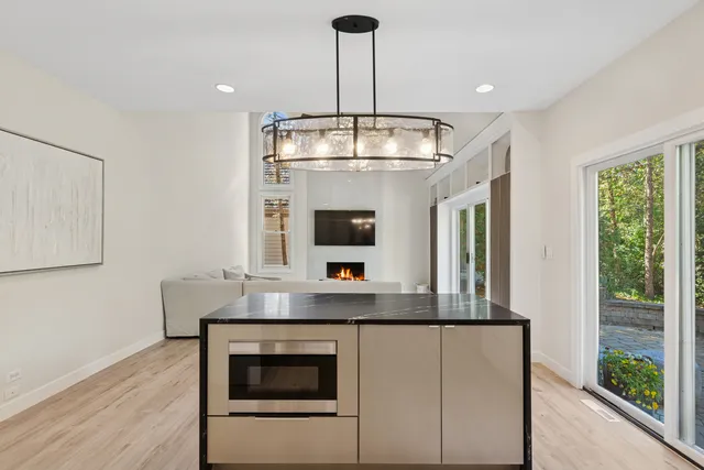 a kitchen with a stove and a wooden floor