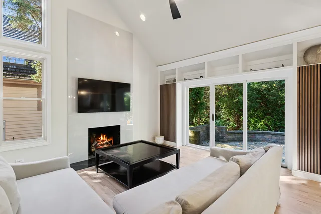 a living room with furniture a fireplace and a flat screen tv