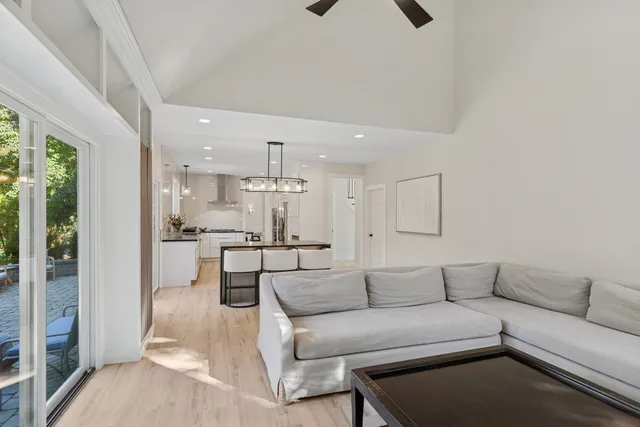 a living room with furniture and a view of kitchen