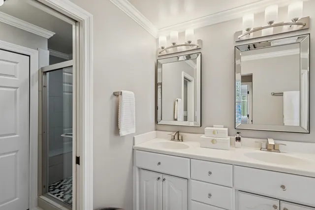 a bathroom with double vanity sinks and a mirror