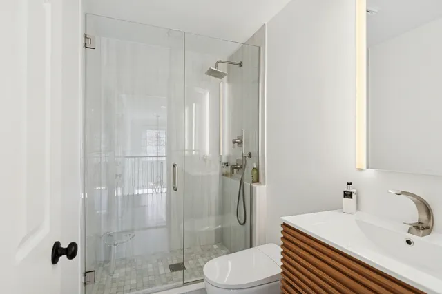 a bathroom with a sink toilet and shower