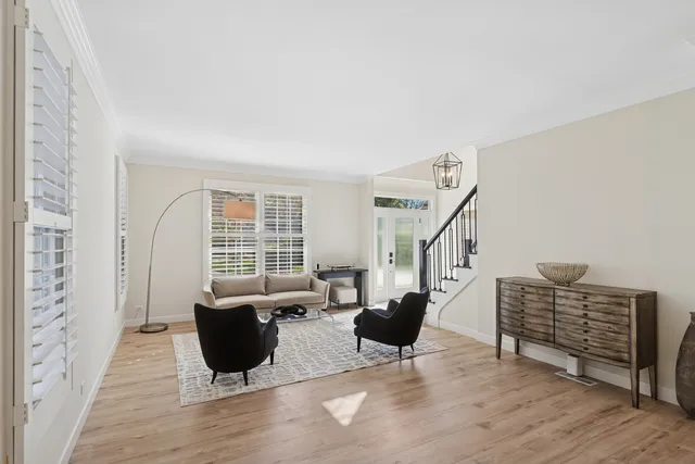 a living room with furniture a rug and a window