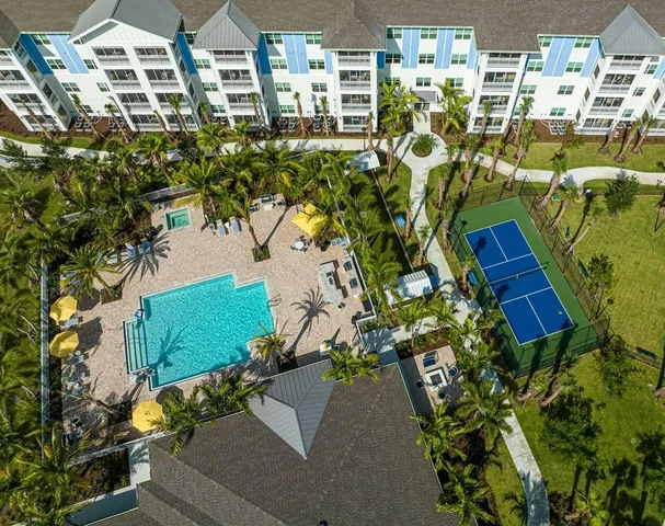 a view of swimming pool with outdoor seating and a garden