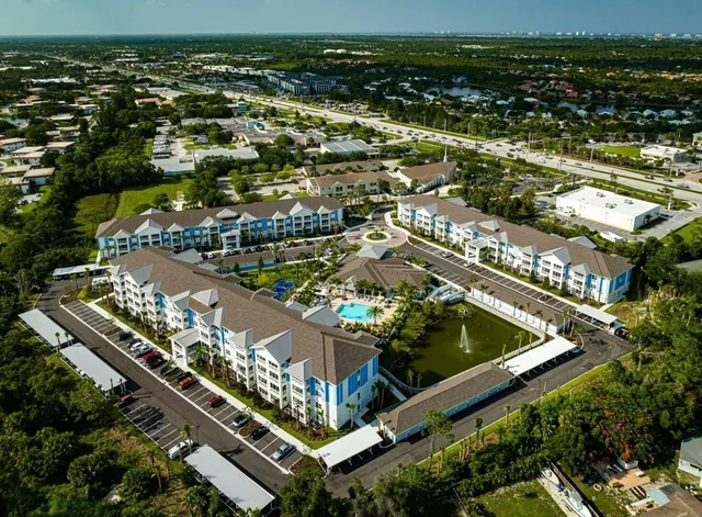 an aerial view of residential building and lake