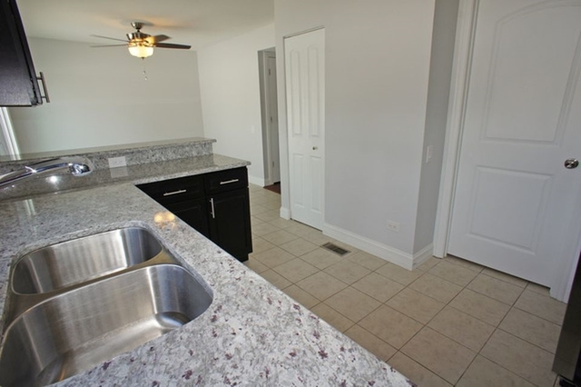 126 North Oltendorf Road Streamwood, IL 60107 - Photo 6 of 16 a kitchen with a sink and a refrigerator