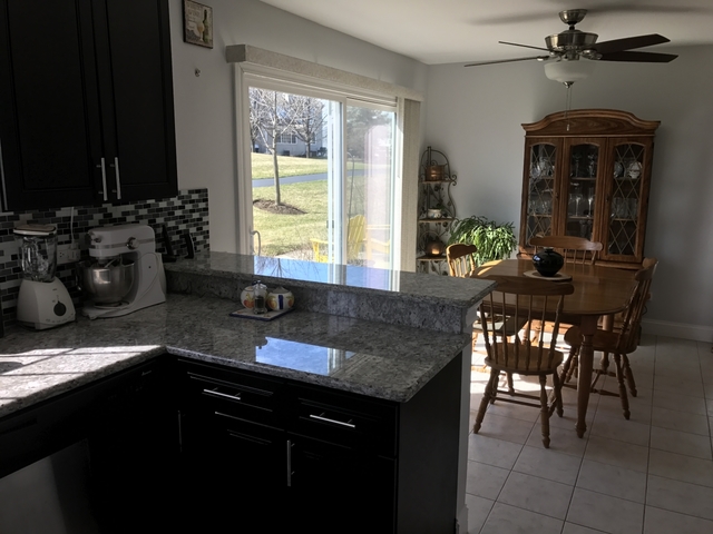 126 North Oltendorf Road Streamwood, IL 60107 - Photo 7 of 16 a kitchen with a granite countertop sink stove and dining table