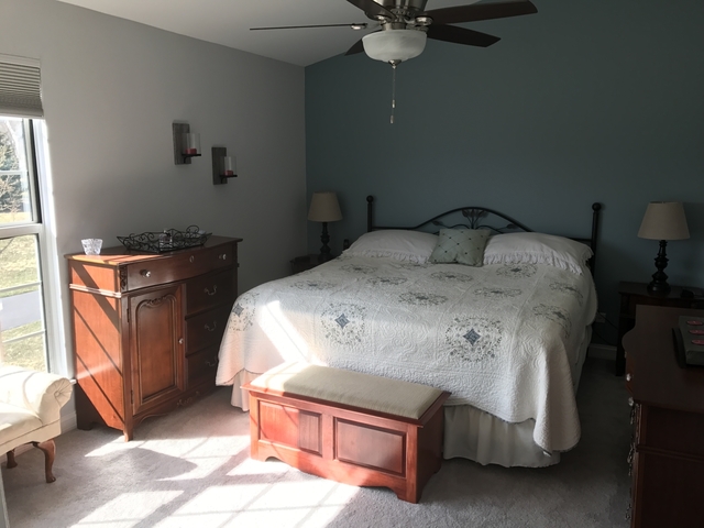 126 North Oltendorf Road Streamwood, IL 60107 - Photo 9 of 16 a bed sitting in a bedroom next to a window