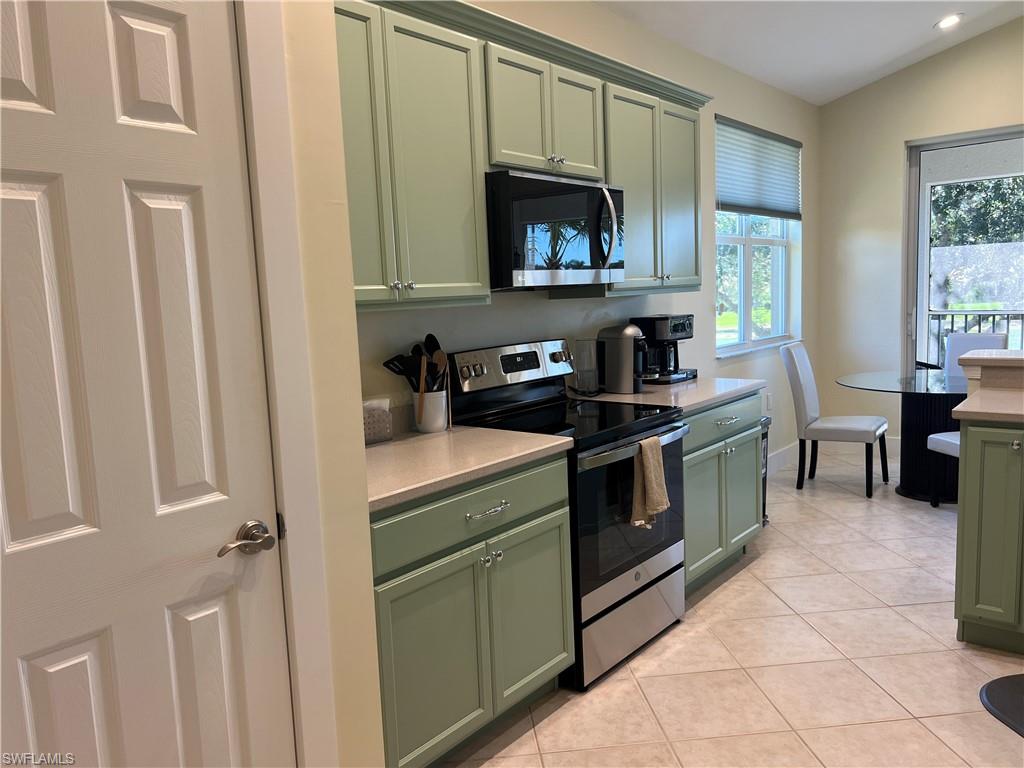 6809 Ascot Drive, Unit 201 Naples, FL 34113 - Photo 14 of 37 a kitchen with a stove and a microwave