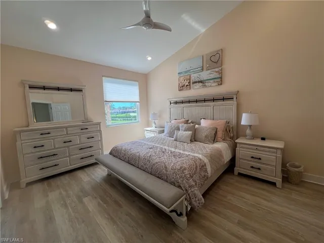 a spacious bedroom with a bed and a dresser