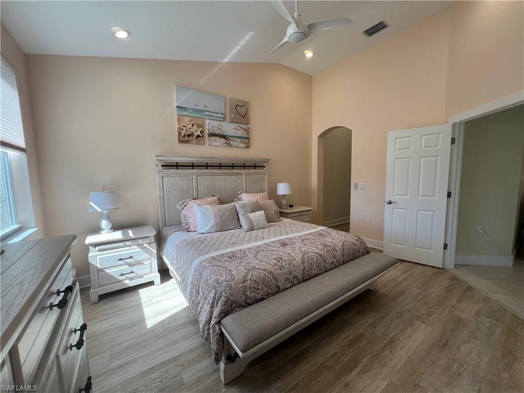 6809 Ascot Drive, Unit 201 Naples, FL 34113 - Photo 17 of 37 a bedroom with a bed and a painting