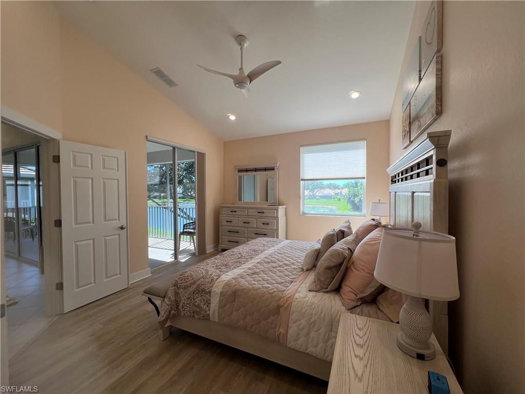 6809 Ascot Drive, Unit 201 Naples, FL 34113 - Photo 18 of 37 a bedroom with a large bed and a window