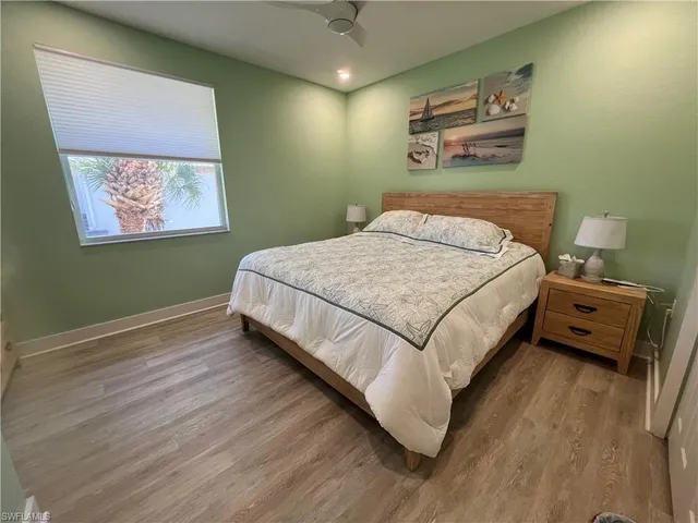 a bedroom with a bed and a painting on the wall