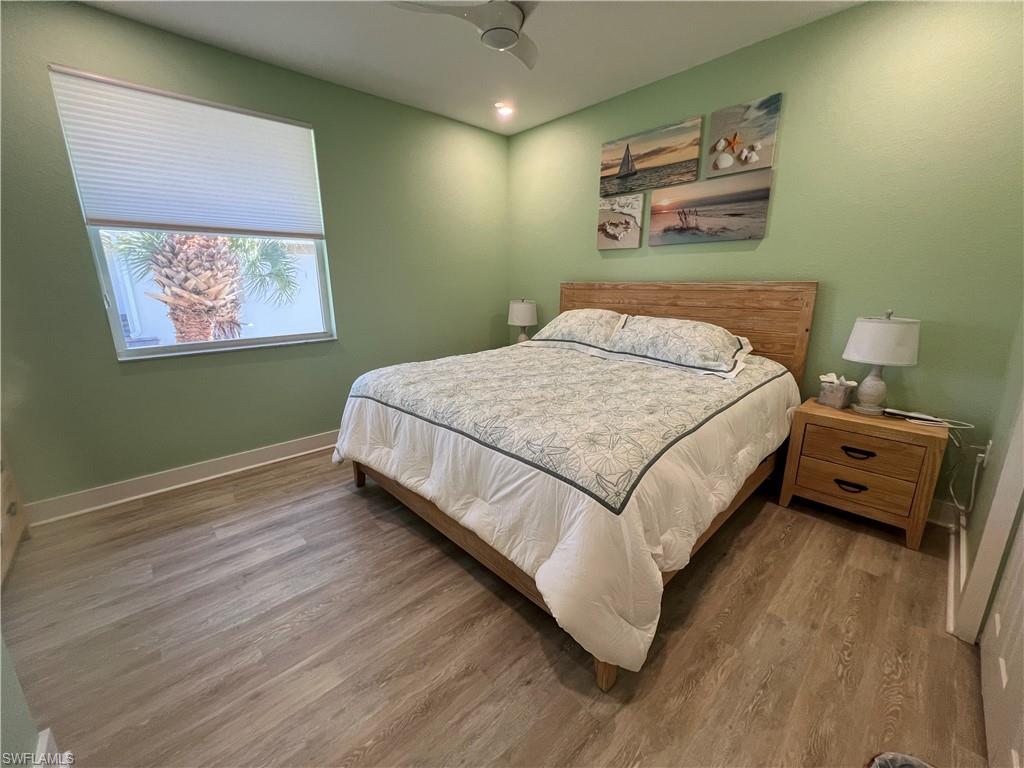 6809 Ascot Drive, Unit 201 Naples, FL 34113 - Photo 21 of 37 a bedroom with a bed and a painting on the wall