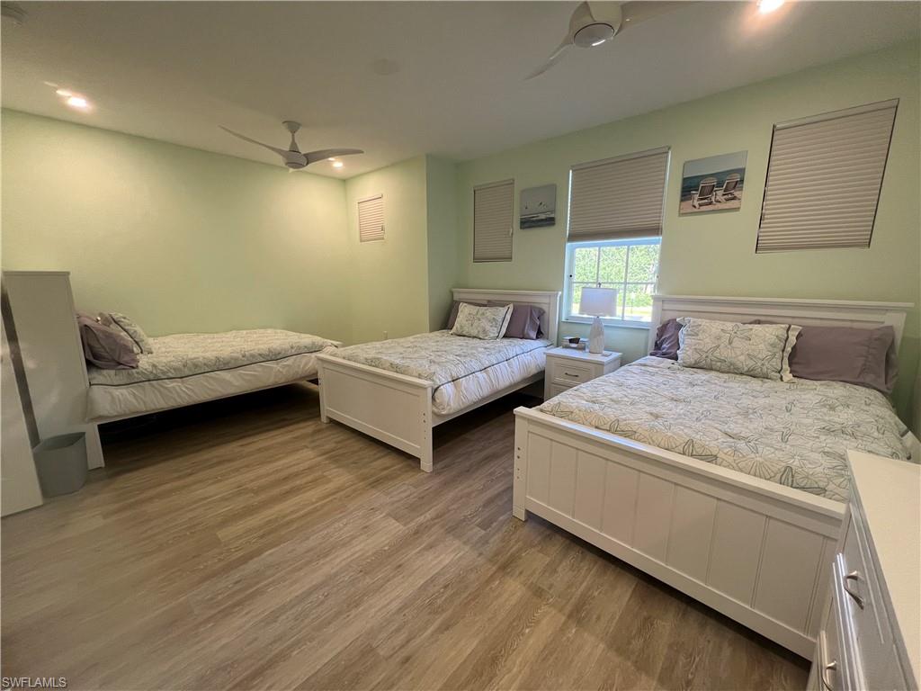 6809 Ascot Drive, Unit 201 Naples, FL 34113 - Photo 23 of 37 a bedroom with two beds and painted walls