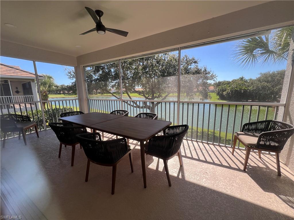 6809 Ascot Drive, Unit 201 Naples, FL 34113 - Photo 3 of 37 a view of a patio with a table chairs and a yard