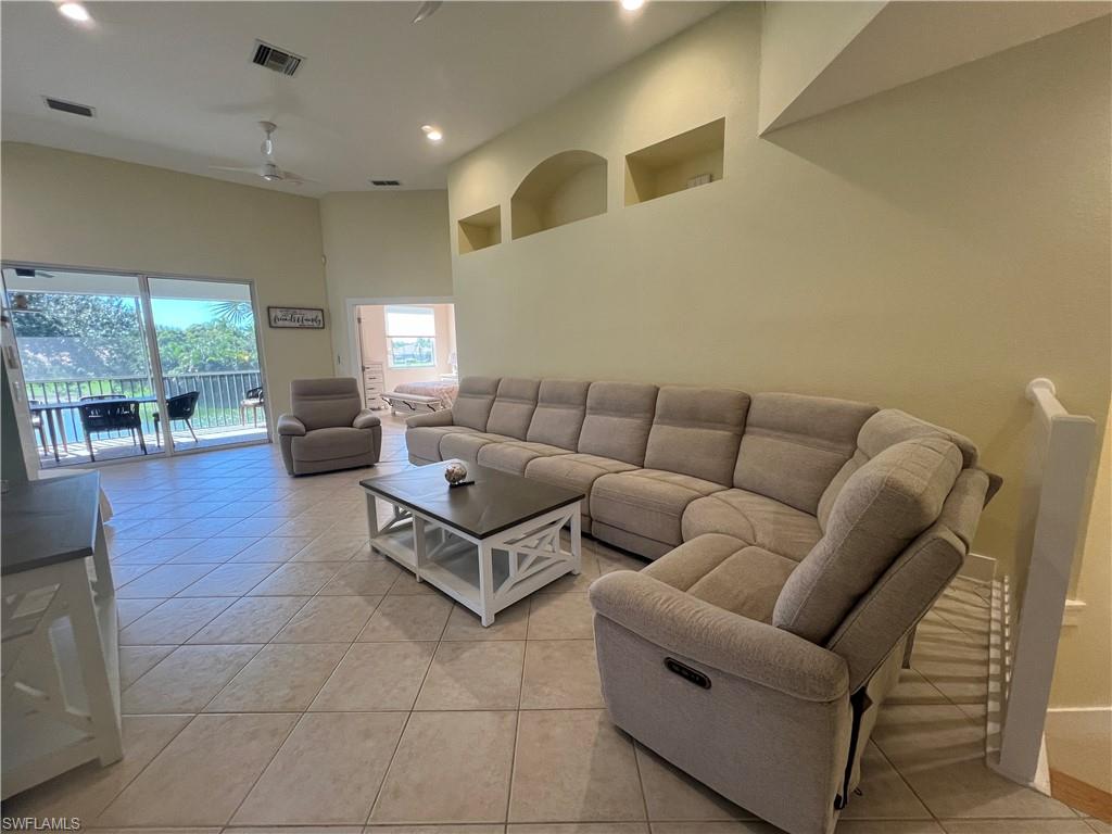 6809 Ascot Drive, Unit 201 Naples, FL 34113 - Photo 4 of 37 a living room with furniture and a fireplace