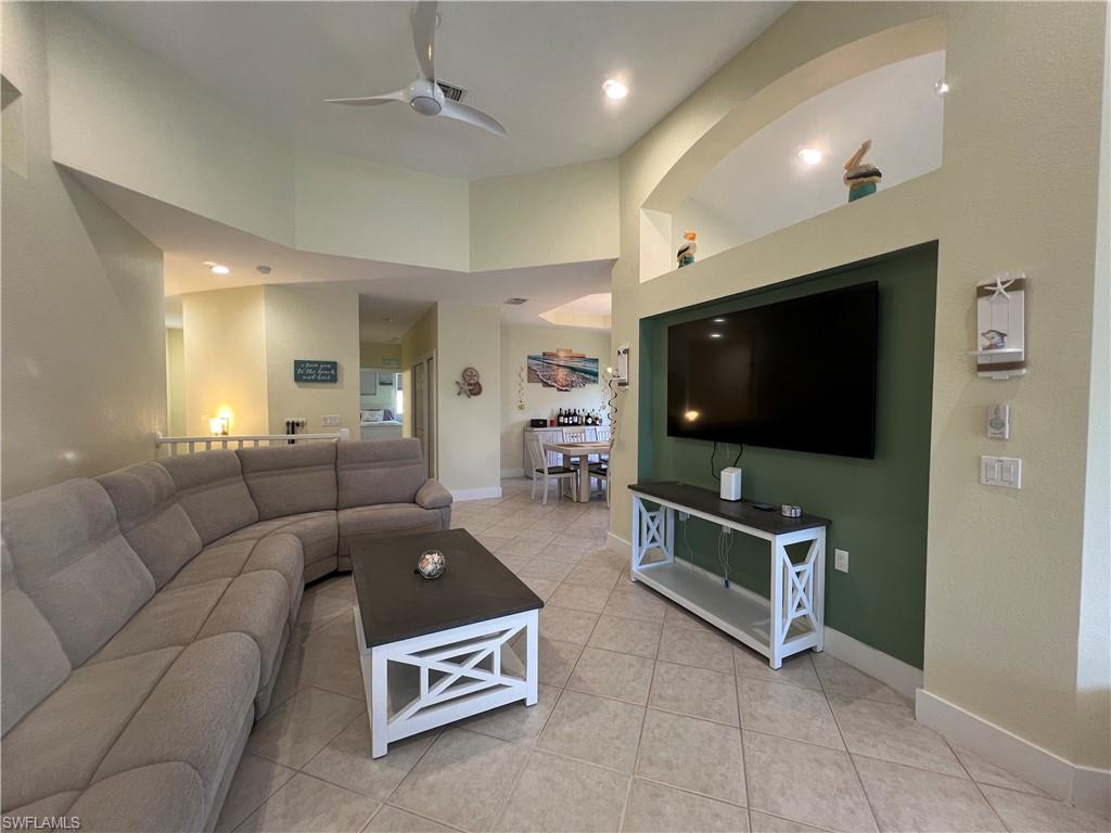 6809 Ascot Drive, Unit 201 Naples, FL 34113 - Photo 9 of 37 a living room with furniture and a flat screen tv