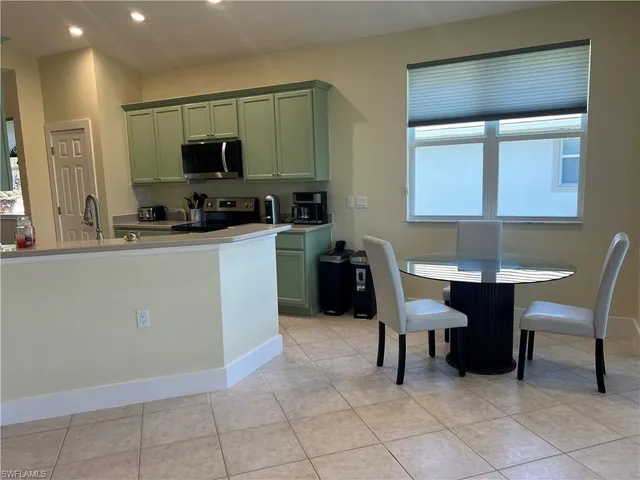 a kitchen with a sink cabinets and wooden floor