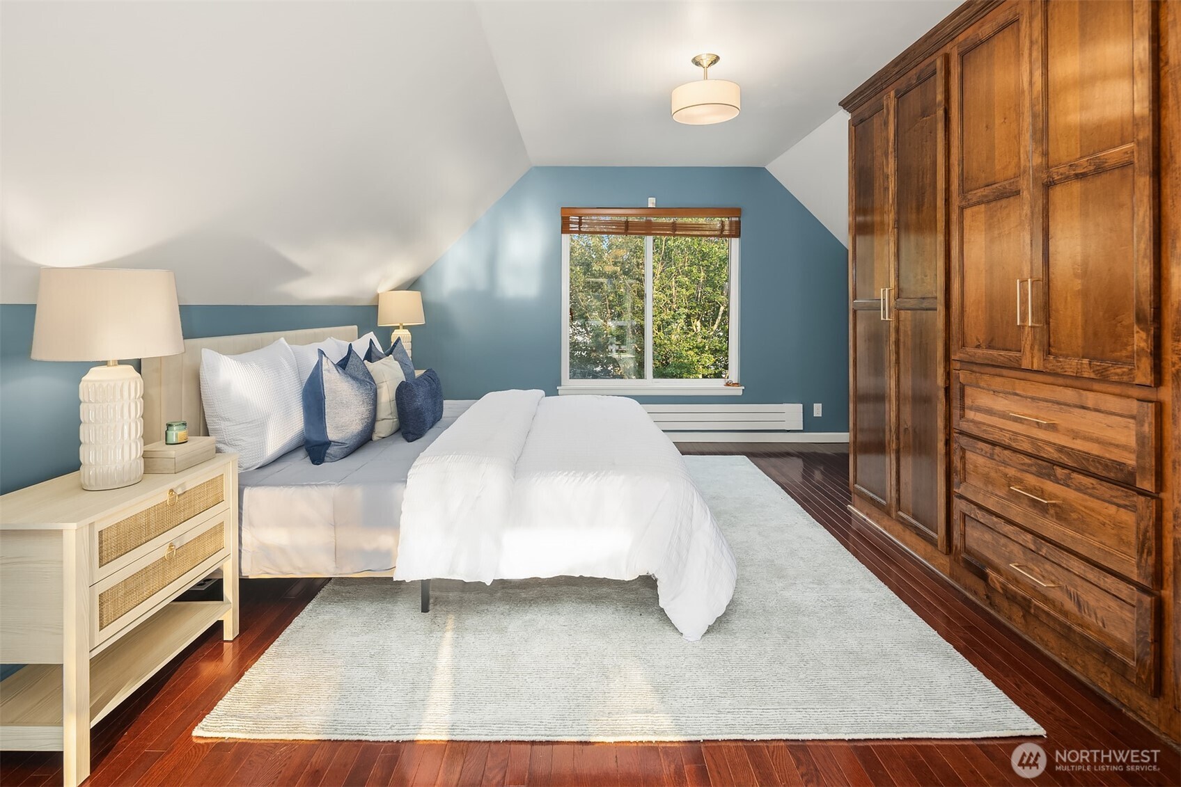 1629 22nd Avenue Seattle, WA 98122 - Photo 28 of 38 a bed sitting in a bedroom next to a window