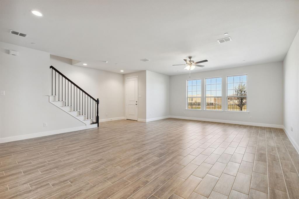 6028 Bursey Road Watauga, TX 76148 - Photo 5 of 27 a view of an empty room with a window and wooden floor