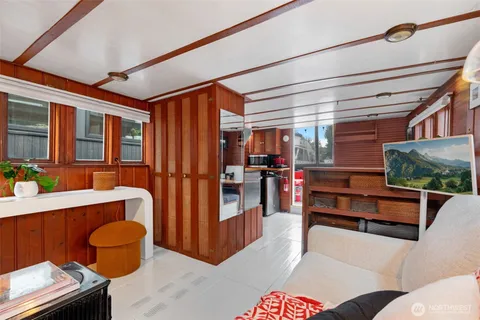 a living room with furniture a rug and a window