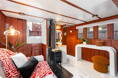 a living room with furniture a chandelier and a window