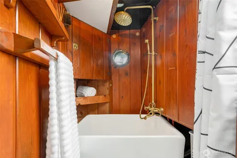 a bathroom with a bathtub and shower
