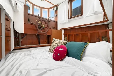 a bedroom with a bed and a painting on the wall