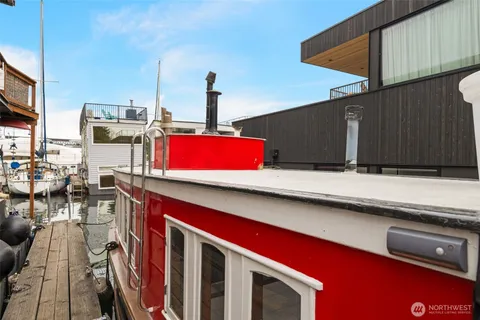 a kitchen with a sink dishwasher and a stove with wooden floor