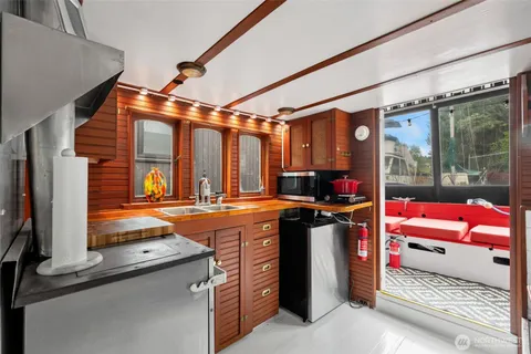 a utility room with stainless steel appliances granite countertop a stove and a refrigerator