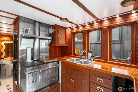 a kitchen with stainless steel appliances granite countertop a sink a stove and a microwave