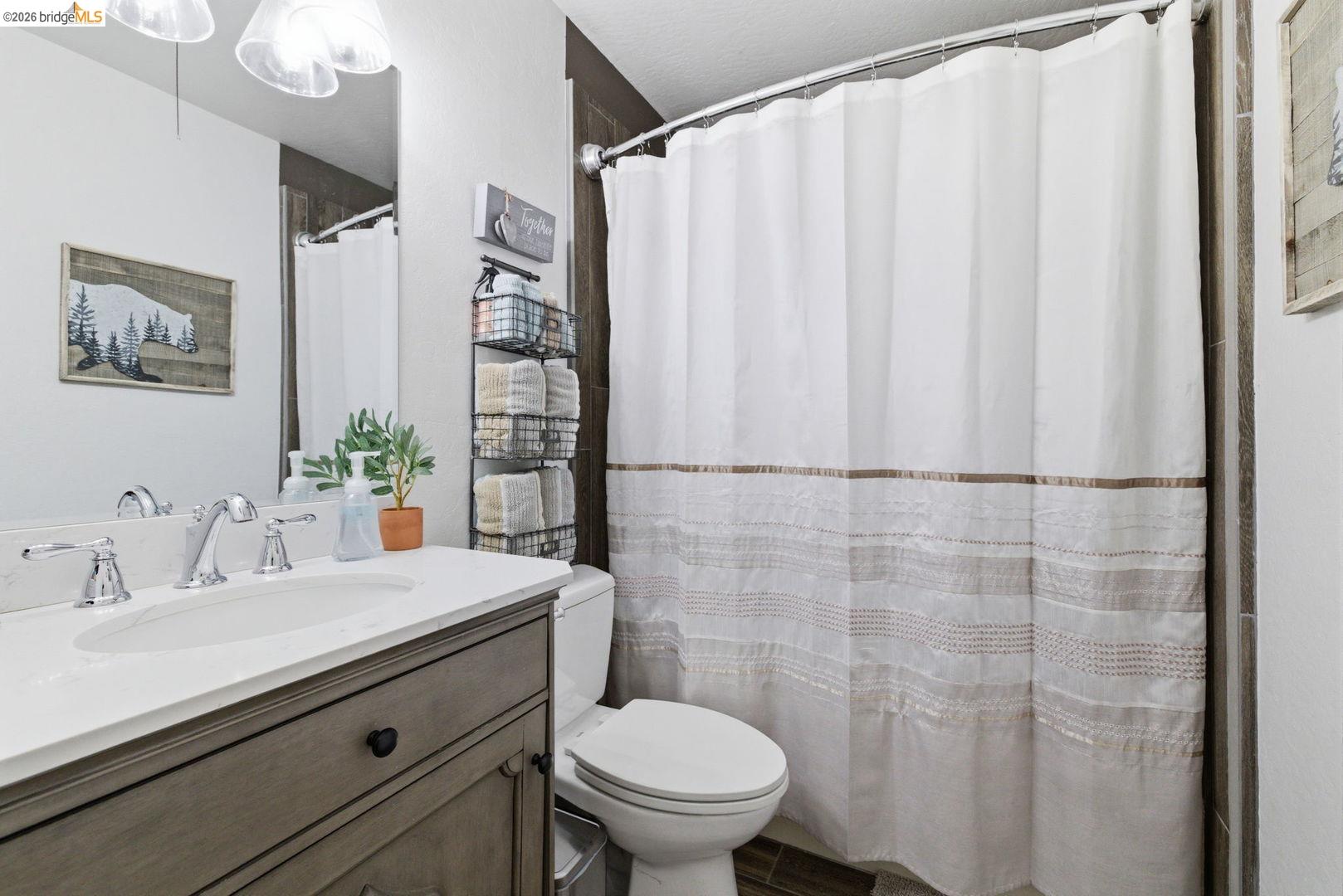 33840 Upper Leland Road, Unit 25A Pinecrest, CA 95364 - Photo 19 of 41 a bathroom with a sink a toilet and shower curtain