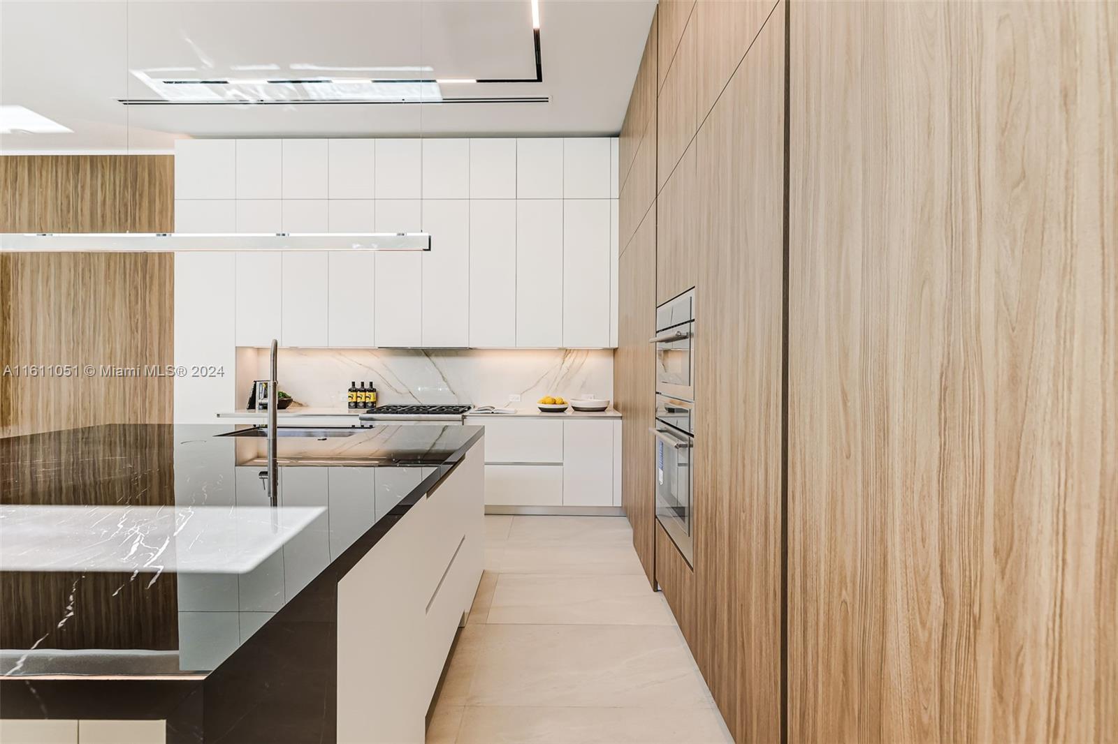 2832 Coconut Avenue, Unit 2832 Miami, FL 33133 - Photo 3 of 24 a bathroom with a granite countertop sink and a bathtub