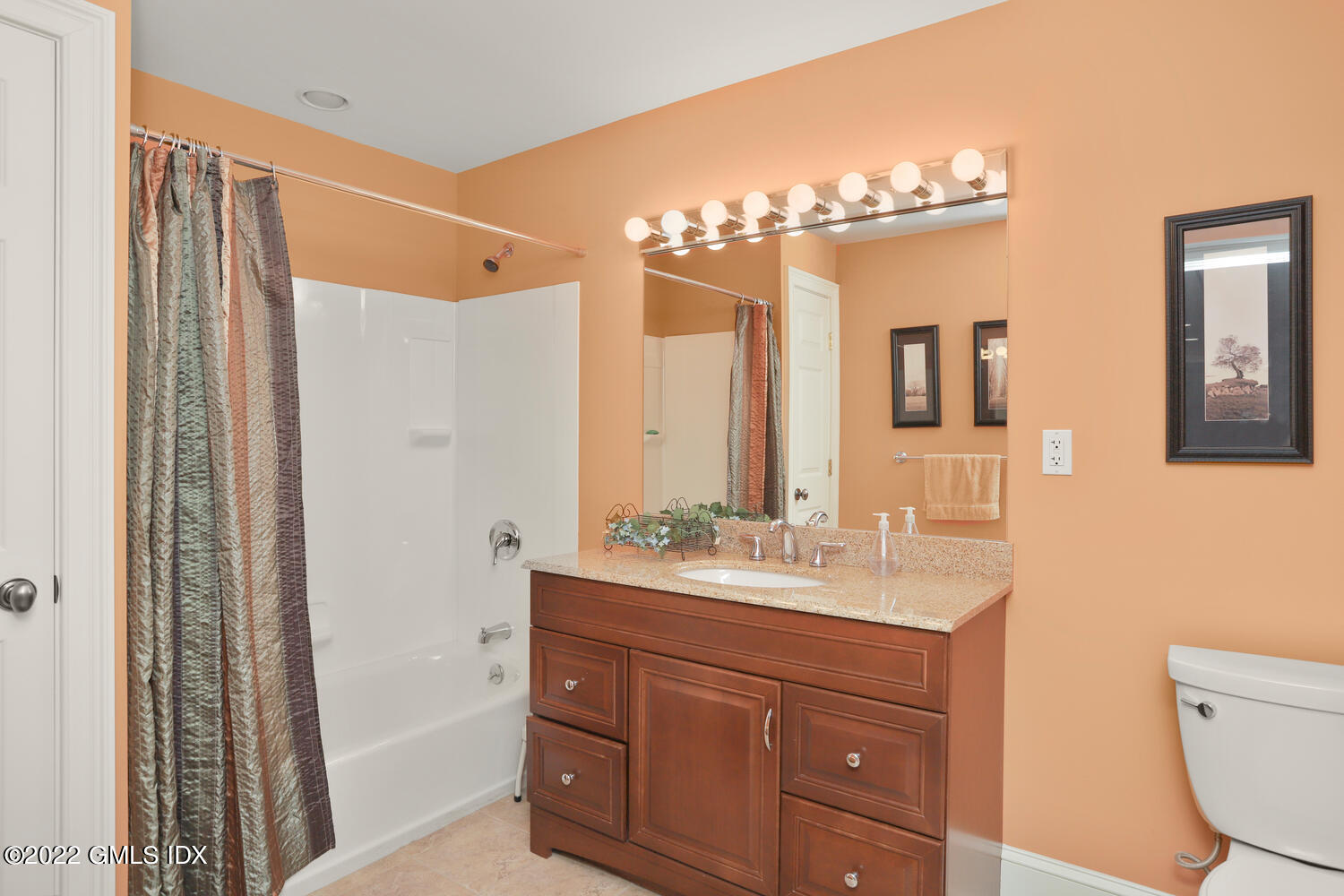 9 Robin Place Old Greenwich, CT 06870 - Photo 40 of 51 a bathroom with a double vanity sink a toilet a mirror and shower