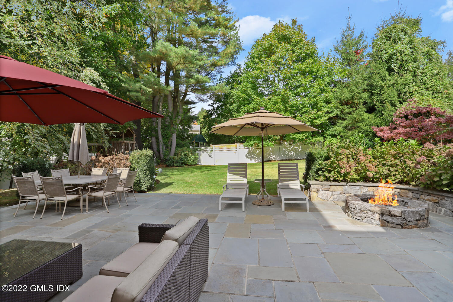 9 Robin Place Old Greenwich, CT 06870 - Photo 42 of 51 a view of a patio with a table and chairs under an umbrella