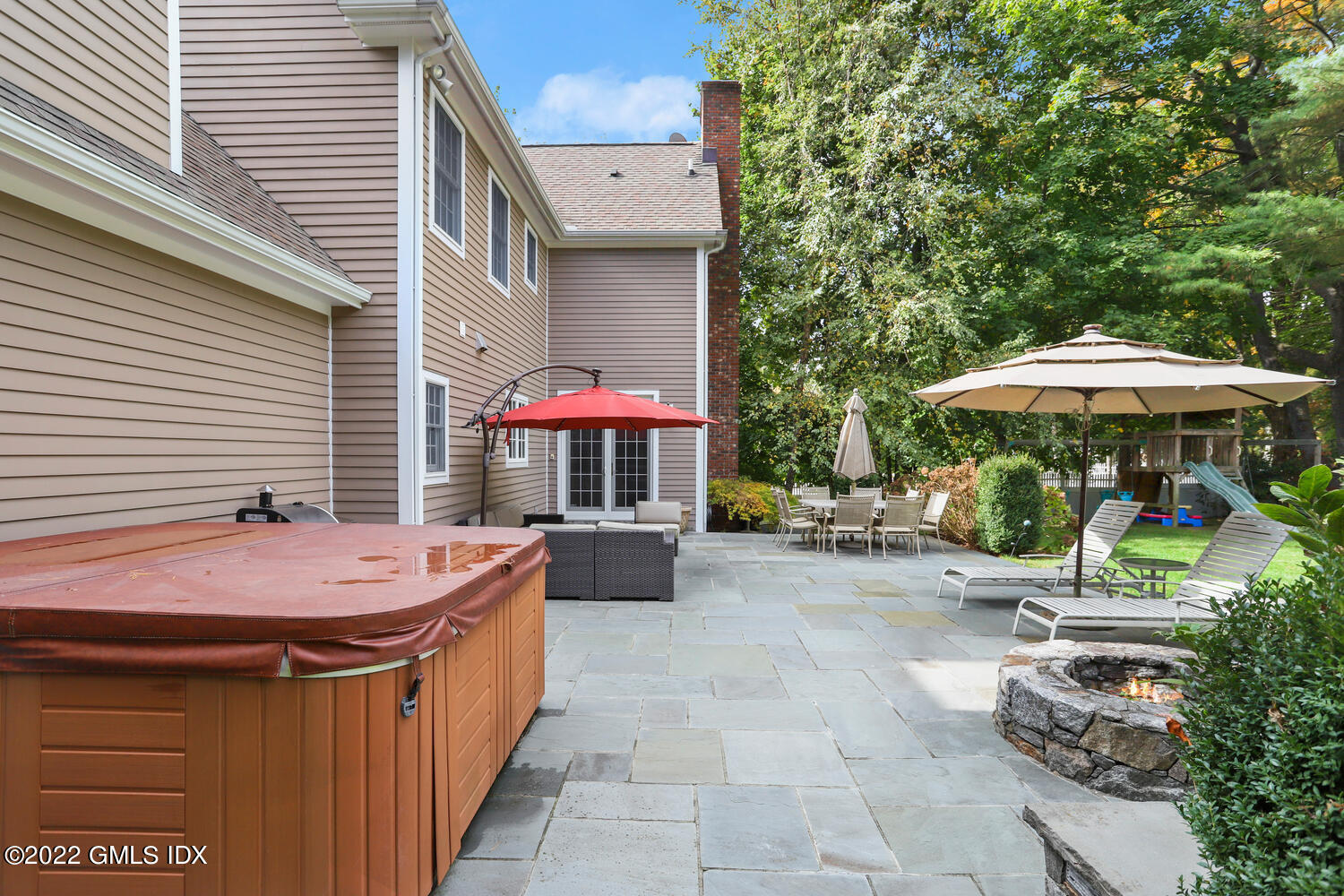 9 Robin Place Old Greenwich, CT 06870 - Photo 43 of 51 a patio with a table and chairs under an umbrella