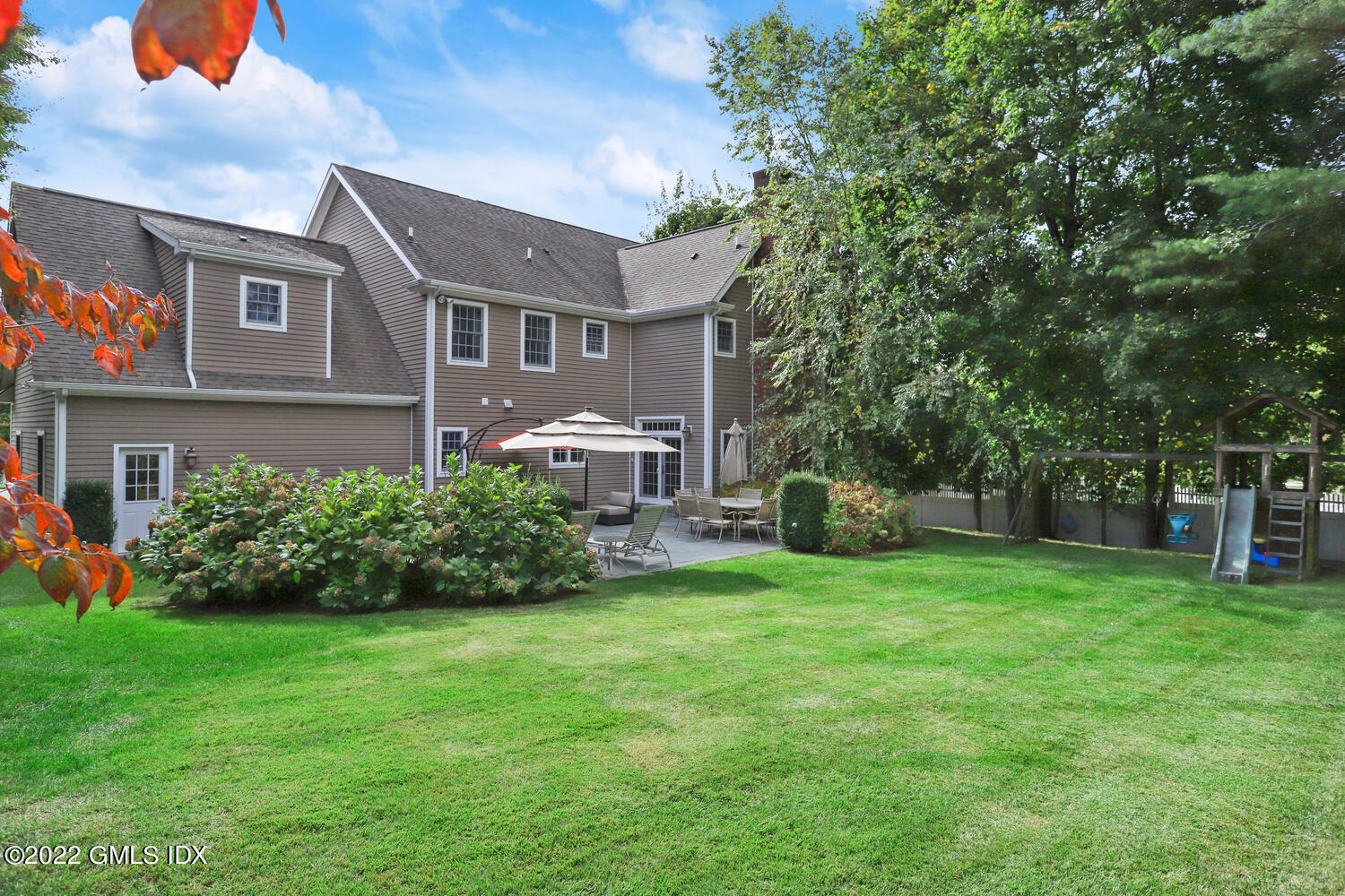 9 Robin Place Old Greenwich, CT 06870 - Photo 44 of 51 a front view of a house with a yard and trees