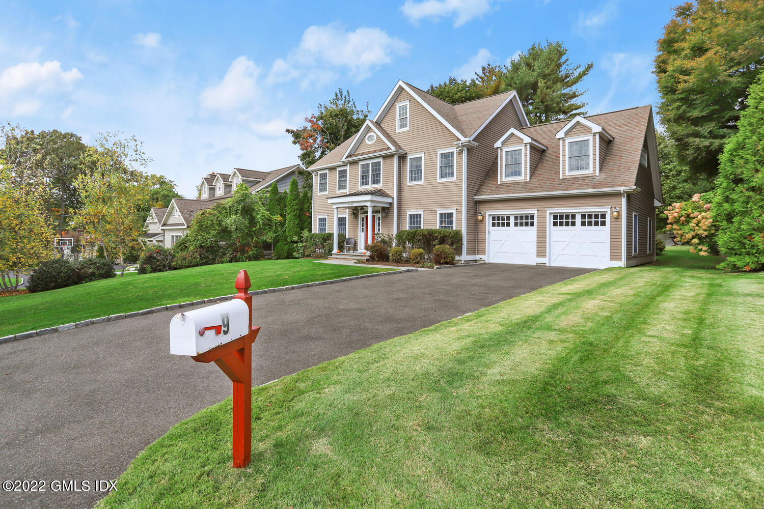 9 Robin Place Old Greenwich, CT 06870 - Photo 48 of 51 a front view of a house with a garden and a tree