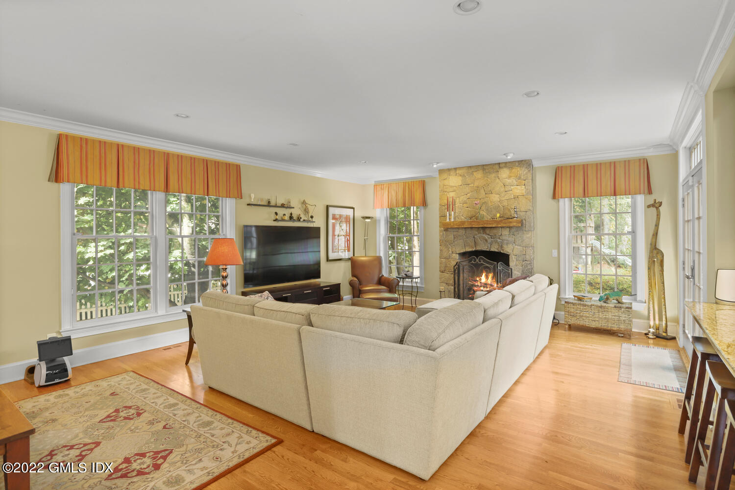 9 Robin Place Old Greenwich, CT 06870 - Photo 10 of 51 a living room with furniture a fireplace and a flat screen tv