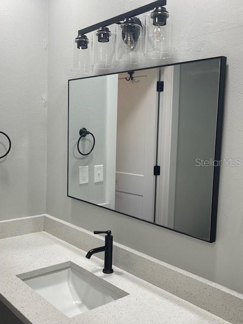 12149 Armenia Gables Circle, Unit 12149 Tampa, FL 33612 - Photo 18 of 27 a bathroom with a sink and a mirror