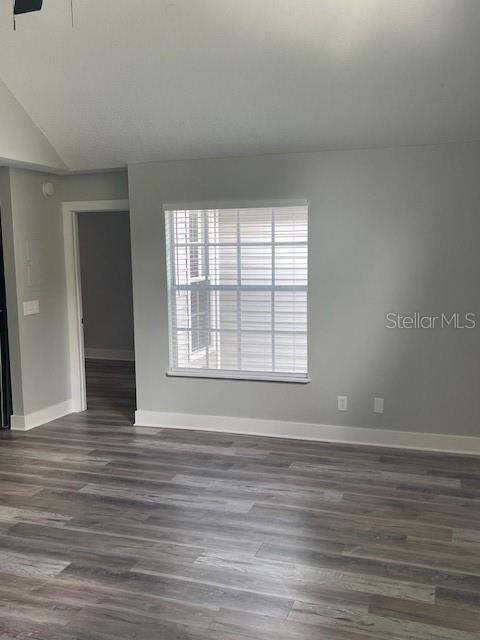 12149 Armenia Gables Circle, Unit 12149 Tampa, FL 33612 - Photo 19 of 27 a view of an empty room with wooden floor and a window